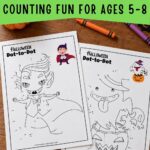 Pinterest image for Halloween connect-the-dots printables showing vampire and ghost worksheets on a wooden table, with crayons and text reading “Counting fun for ages 5–8.”